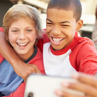 Two boys taking a selfie on a playground