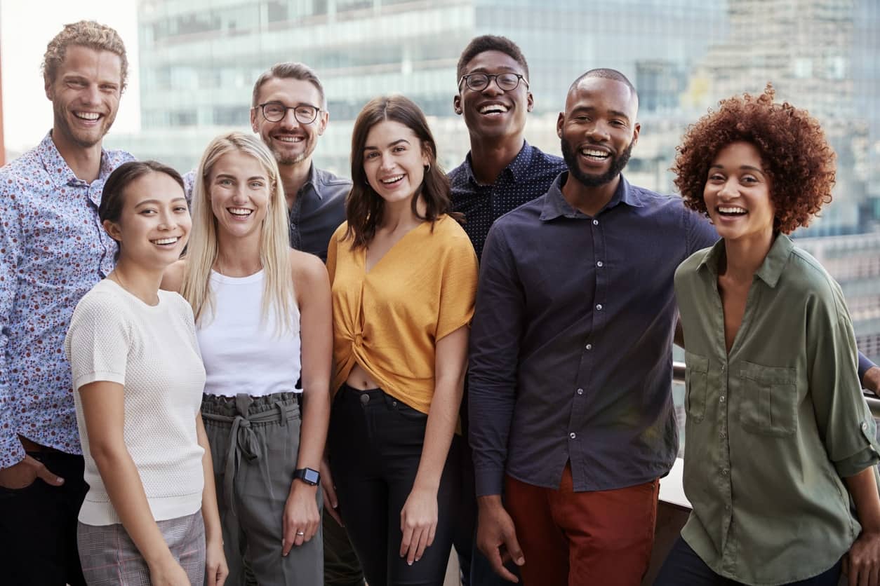 Stock photo of fairly diverse young professionals on a balcony in front of a skyscraper
