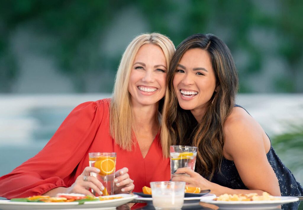 Two woman with braces for adults in Columbus smiling while having brunch together