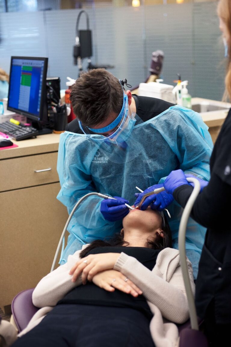 Orthodontist near Lancaster Ohio, Dr. Jesse Carmen adjusting braces in dental PPE.