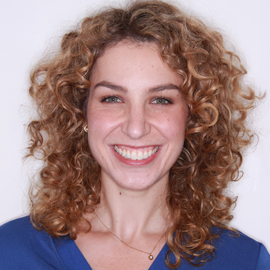 Expert Orthodontist Dr. Sabrina smiling in a blue shirt