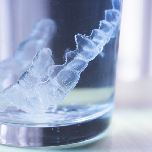 Invisible dental orthodontic submerged in water for cleaning