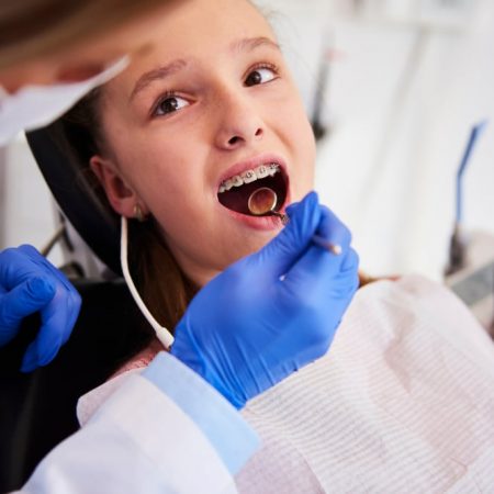 Part,Of,Orthodontist,Examining,Child's,Teeth,In,Dentist's,Office