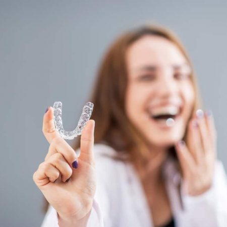 Beautiful,Smiling,Turkish,Woman,Is,Holding,An,Invisalign,Bracer,In